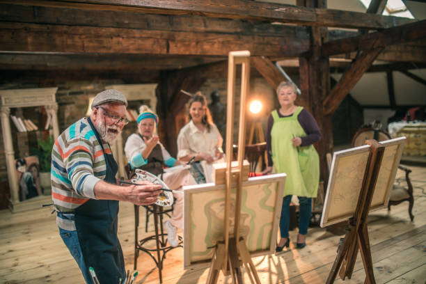 istock group of seniors attending art class with teacher 1488279051