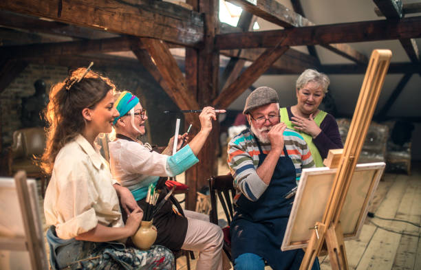 group of seniors attending art class with teacher