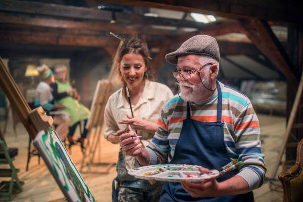 istock group of seniors attending art class with teacher 1488285199