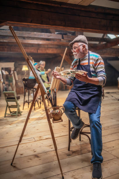 istock group of seniors attending art class with teacher 1488285235