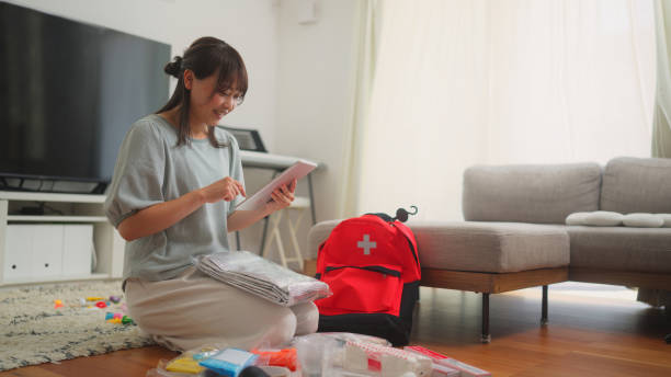 Woman preparing emergency bag at home