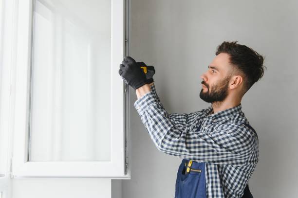 istock Worker in installing white plastic upvc window on house. 1488292586