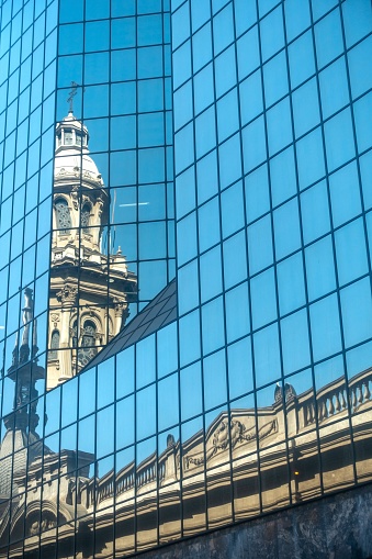 Vertical Portrait of Famous Santiago Metropolitan Cathedral (Catedral Metropolitana de Santiago de Chile) reflected in City Center Office Building Glass Windows