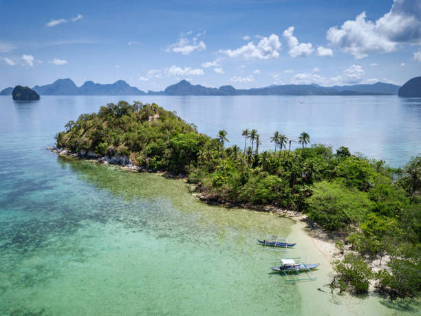 El Nido Palawan Vigan Island Beach Philippines El Nido Palawan Archipelago Vigan Island Beach with Tourists and anchored Bangka Boats. Aerial Drone Point of View towards the small perfect hideaway. Vigan Island, Bacuit Bay, El Nido, Palawan Island, Philippines, Asia philippines landscape stock pictures, royalty-free photos & images