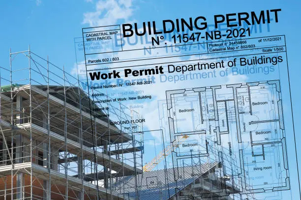 Photo of Buildings Permit project concept with residential building construction and metal scaffolding on a construction site