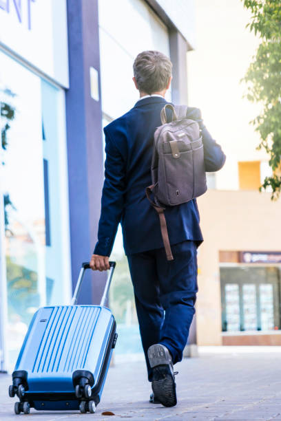 istock Businessman walking down the street with a suitcase 1488298326