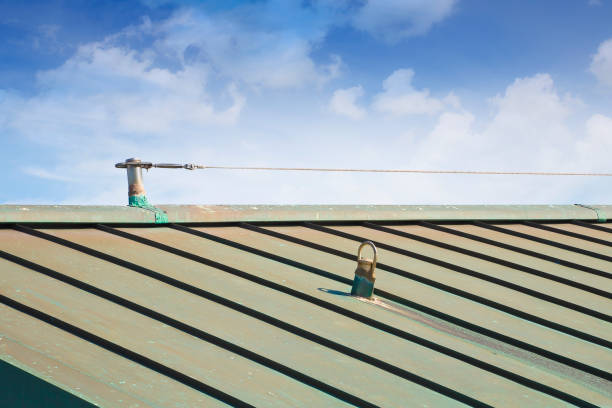 istock Horizontal lifeline fall protection system with inox stainless steel cable on copper roof used to prevent the danger of falling - buildings and safely access all areas of a rooftop 1488299172
