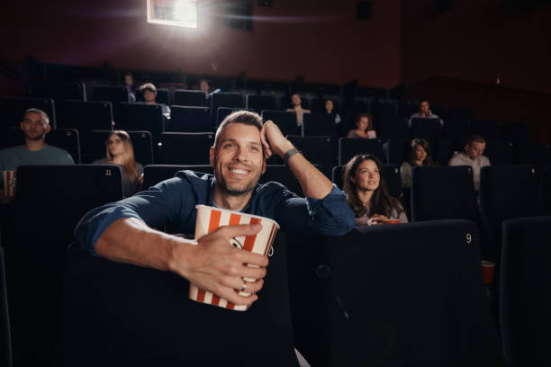 istock Happy man enjoying while watching a movie in cinema. 1488299939