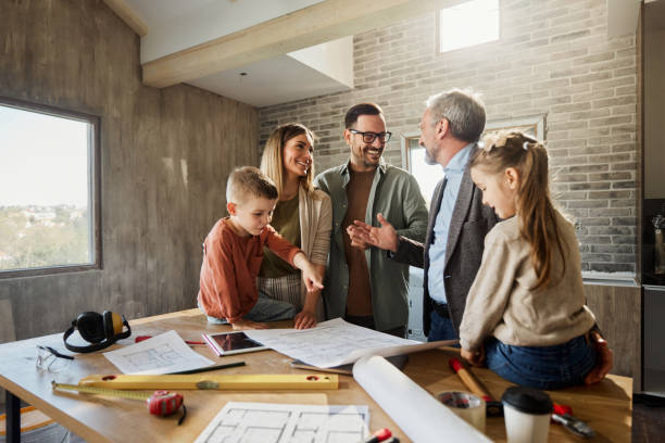 Happy family talking to their architect during home renovation process.