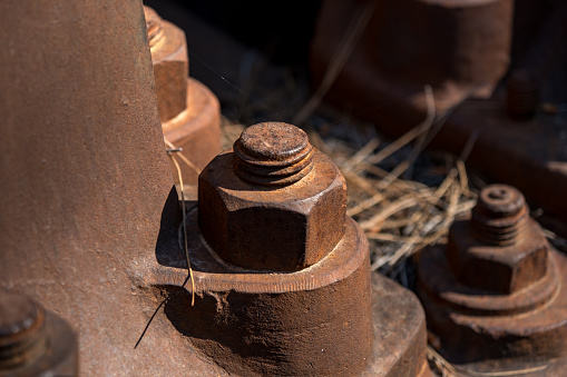 The seals and nuts of the giant machine are rusted, the machine is ruined to be used.Close-up industry.