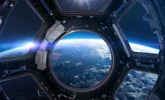 Cupola porthole on space station. ISS window. International space station. Earth planet with stars view. Elements of this image furnished by NASA (url: https://www.nasa.gov/sites/default/files/styles/full_width_feature/public/thumbnails/image/iss043e284928.jpg https://www.nasa.gov/sites/default/files/styles/full_width_feature/public/thumbnails/image/iss060e007297.jpg)