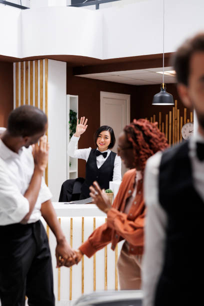 istock Couple saying goodbye to hotel employee 1488309811