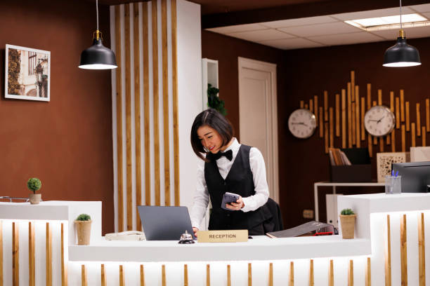 istock Front desk staff holding pos terminal 1488310786