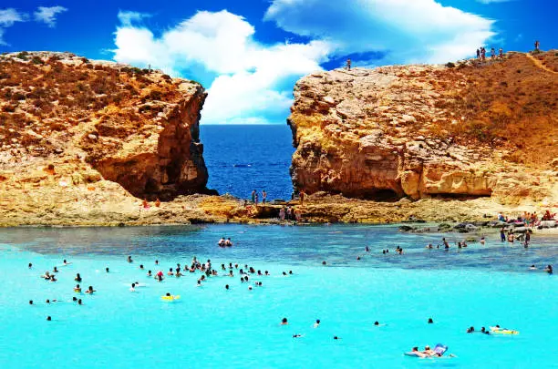 Blue Lagoon, Malta - July 15, 2012: people bathing in amazing turquoise blue sea