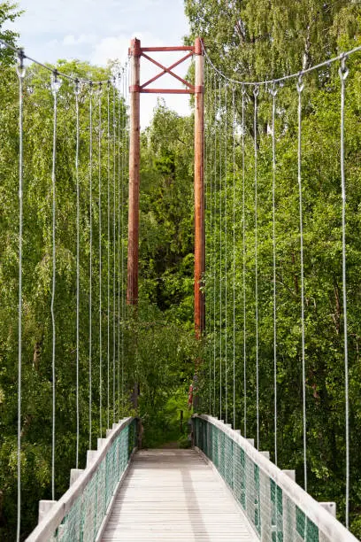 Umea, Norrland Sweden - July 28, 2021: suspension bridge for pedestrians in nature conservation area