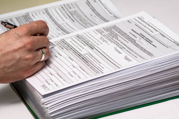 istock A pile of tax forms in a binder on a desk 1488312747