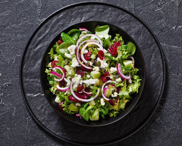 istock Green Salad with Apple, Cheese, Cranberry in bowl 1488312783