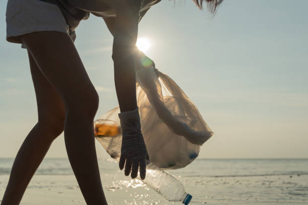 istock Save ocean. Volunteer pick up trash garbage at the beach and plastic bottles are difficult decompose prevent harm aquatic life. Earth, Environment, Greening planet, reduce global warming, Save world 1488312912