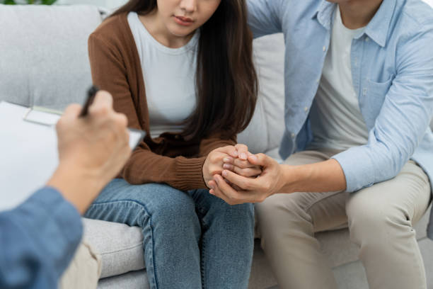 istock Couple hold hand support each while discussing family issues with psychiatrist. Husband encourages and empathy wife suffers depression. psychological, save divorce, Hand in hand together, trust, care 1488312951