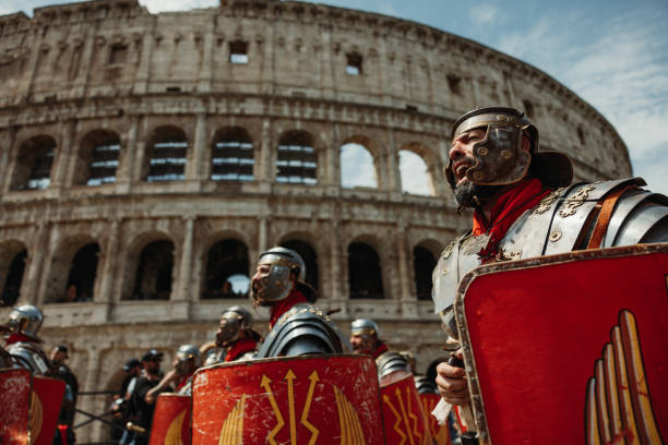 Rome, Italy, April 23, 2023: Parade for the birth of Rome on April 23, 2023 in Rome, Italy. People dressed in costume as gladiators, centurions, senators, handmaids and ancient romans citizens walk in parade under the Coliseum of Rome, to celebrate the birth of the Eternal City.