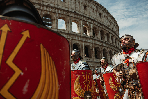 Rome, Italy, April 23, 2023: Parade for the birth of Rome on April 23, 2023 in Rome, Italy. People dressed in costume as gladiators, centurions, senators, handmaids and ancient romans citizens walk in parade under the Coliseum of Rome, to celebrate the birth of the Eternal City.