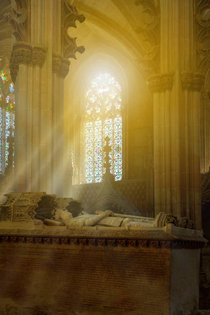 columns and stained glass windows inside a large christian cathedral with king sunlit chamber