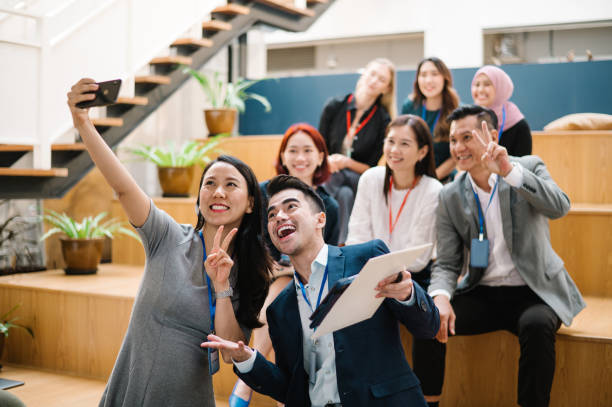 istock Excited conference speaker takes selfie with attendee. 1488318144