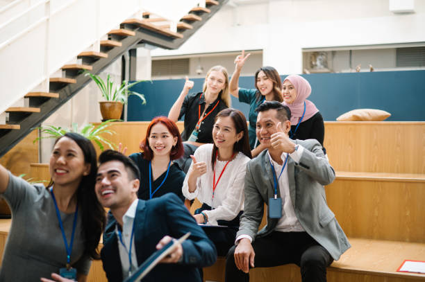 istock Excited conference speaker takes selfie with attendee. 1488318153