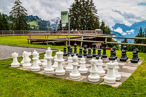 Mont Rigi, Switzerland - August 19, 2016: Giant chess board at Mount Rigi, with scenic view of cloud covered Swiss Alps.