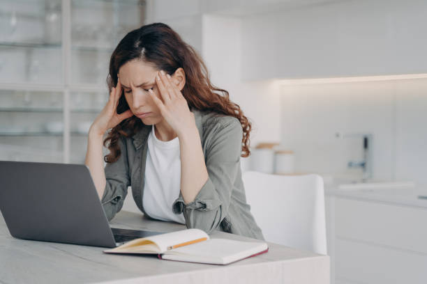 istock Remote education or work at home office. Spanish woman is exhausted from online conference. 1488319629