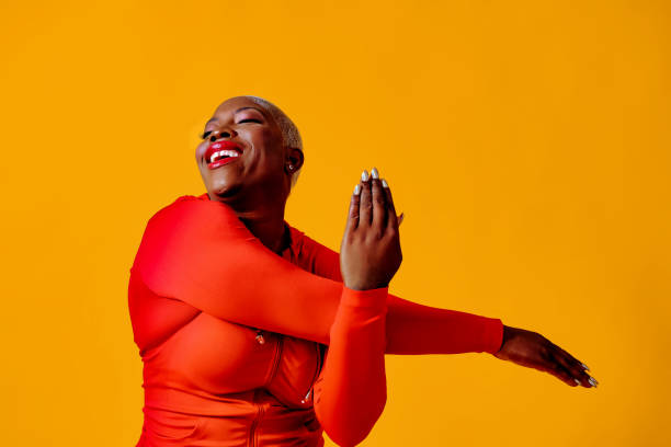 istock woman wearing red jumpsuit stretching arm 1488319921