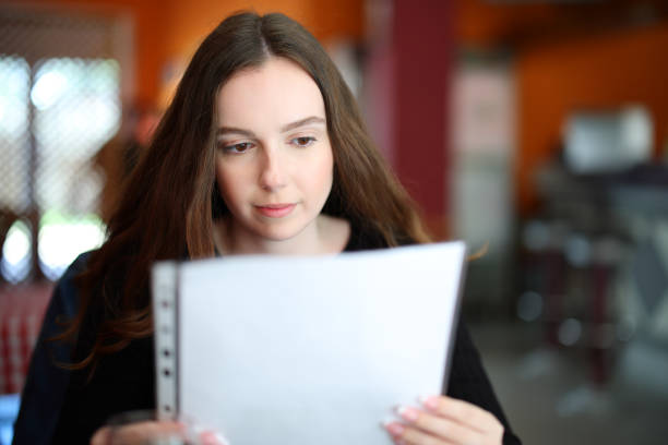 istock Serious woman reading menu in a restaurant 1488320349