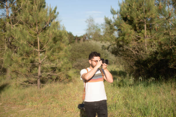 istock Male photographer using a DSLR camera 1488320359