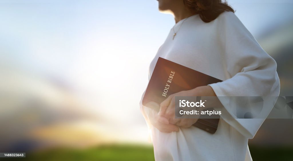 Christian evangelism concept background with church holding holy bible Christian background and worship and evangelism concept with church hand holding holy bible and preaching the gospel of jesus christ Mission Church Stock Photo