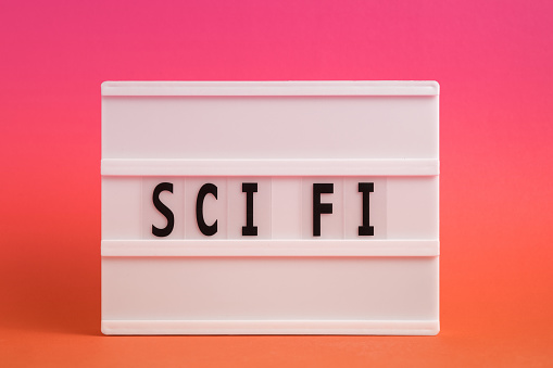 The word Science fiction on lightbox isolated pink background. Literary Genres