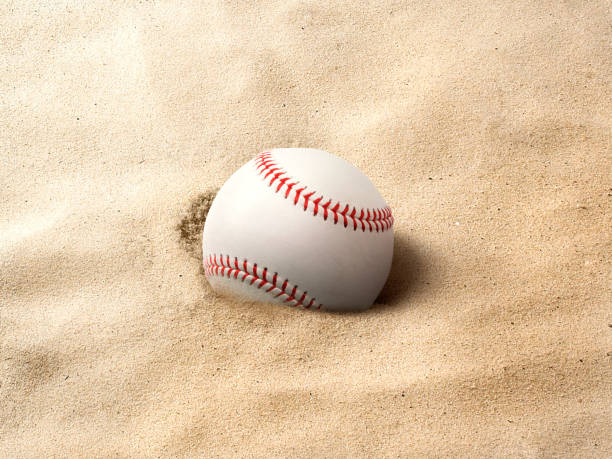 istock baseball ball on the sand background 1488326850