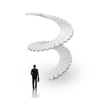 Businessman walking up a spiral staircase on white background