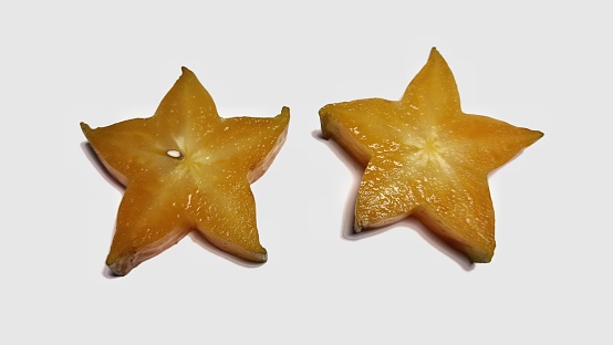 View of cutting starfruit in isolated white background