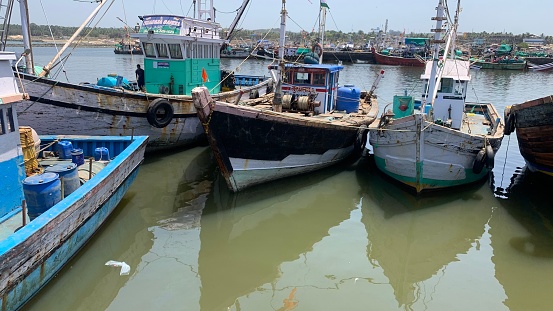 Ratnagiri, Maharashtra, India - April 4 2021 : Fishing boats moored in , Jetty of Ratnagiri, on the west maharashtra coastline in India.