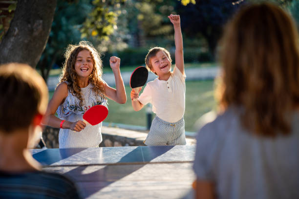 istock Children playing table tennis on summer day 1488331287
