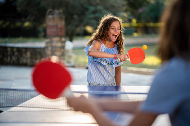istock Girls playing table tennis on summer day 1488331470
