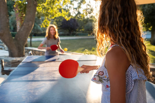 istock Girls playing table tennis on summer day 1488331526
