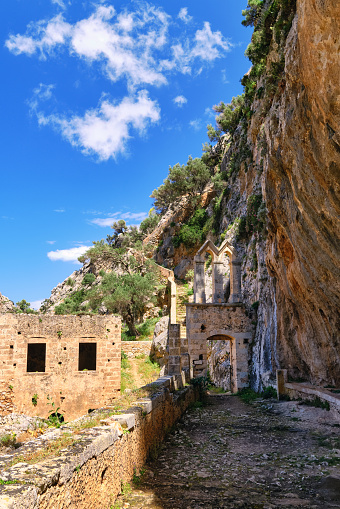 Ruins of entrance gate to abandoned Orthodox Katholiko monastery in Avlaki gorge, Akrotiri peninsula, Chania, Crete, Greece. Spring daytime shot