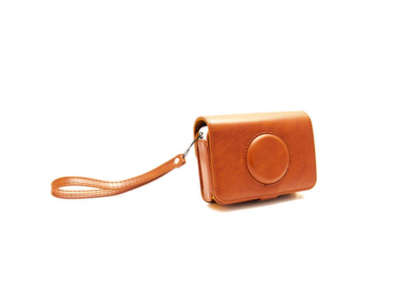 istock Side view brown leather case with strap for instant camera lens protection isolated on white background 1488332188