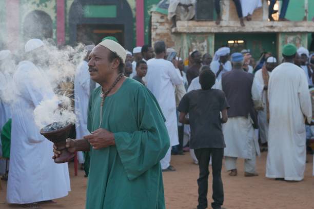 Sudanese sufi priest bathes devotees in incense smoke stock photo