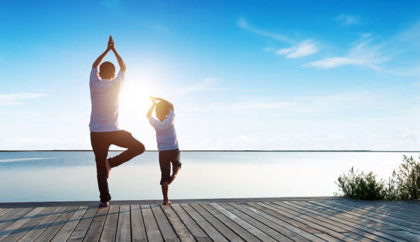 istock Father and son practicing yoga at the seaside 1488333119