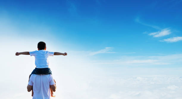 istock Happy father carrying his son on shoulders 1488333120
