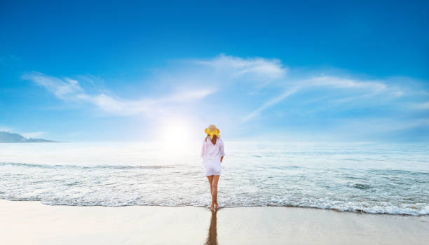 istock Woman standing at the beach 1488333315
