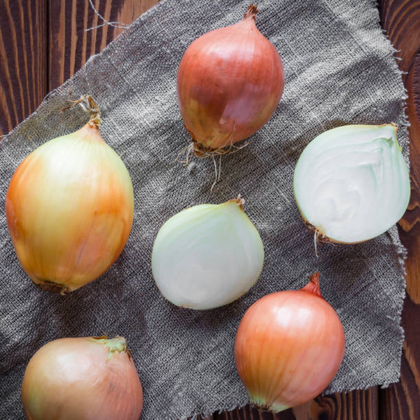 istock raw and sliced onions on a wooden background 1488333790