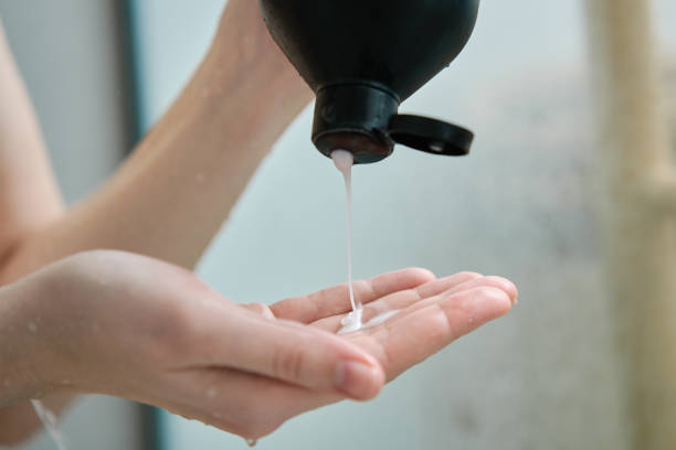 istock Woman pouring shampoo on hand in bathroom 1488333973